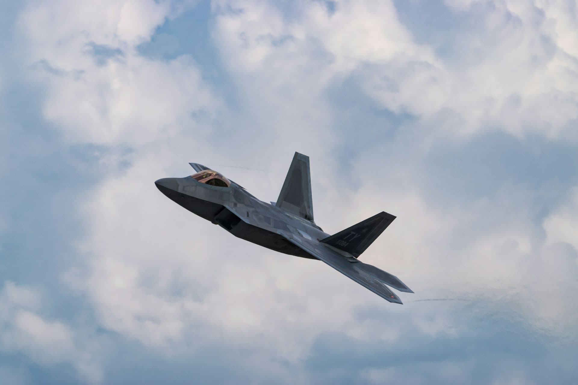 Fighter jet banking through clouds